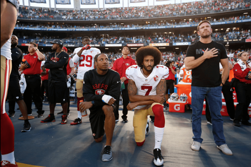 Colin Kaepernick takes a knee. Photo credit: Getty Images