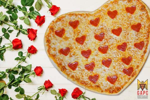 Valentine background of red roses on white wood. Space for copy.