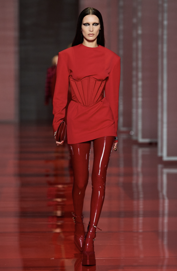 The broad shoulders of this look define the tiny waist of the corset. I love the powerful energy this all-red look serves. Photo credit: Vogue